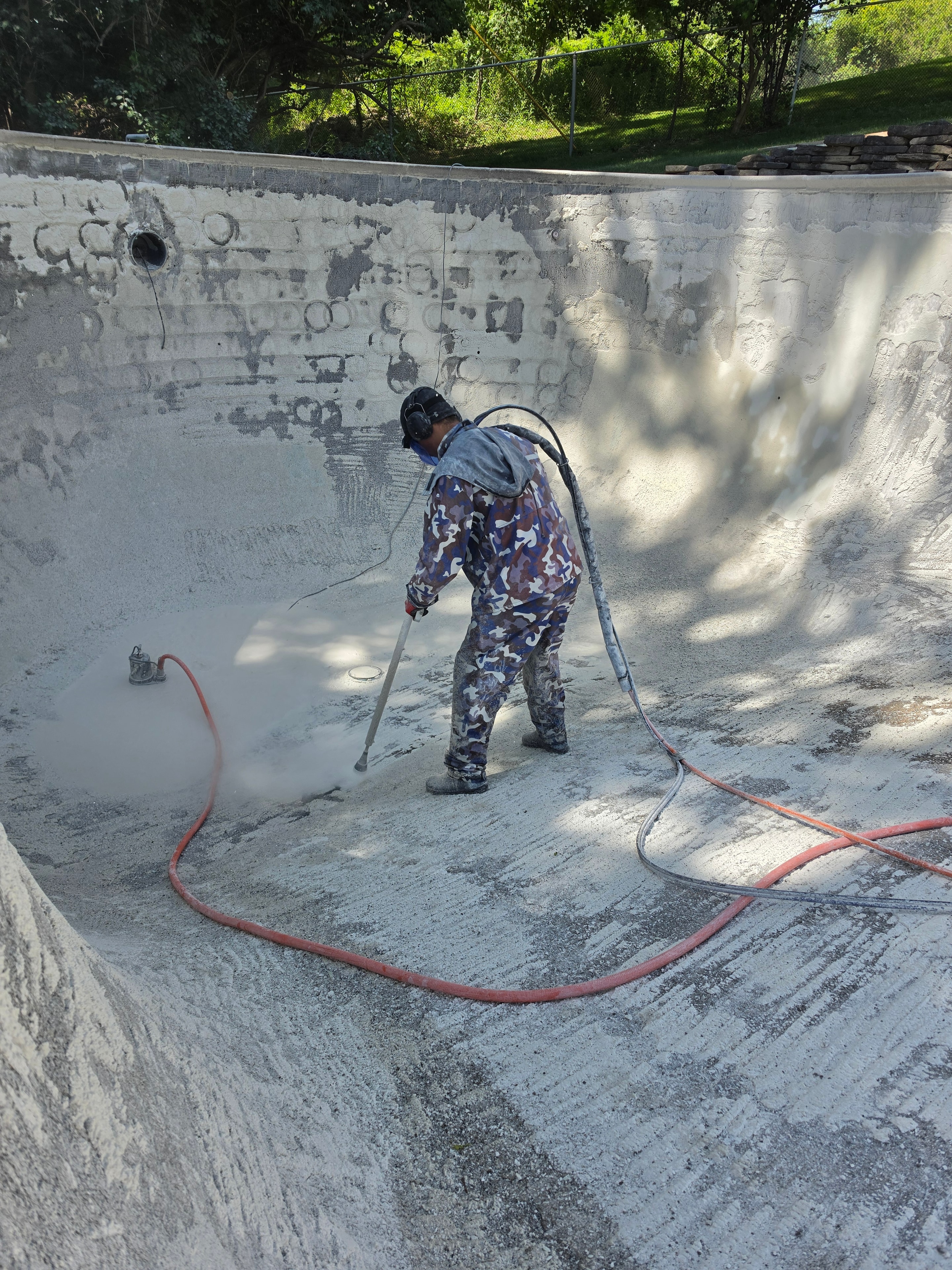 Close-up of pool surface being stripped by hydroblasting